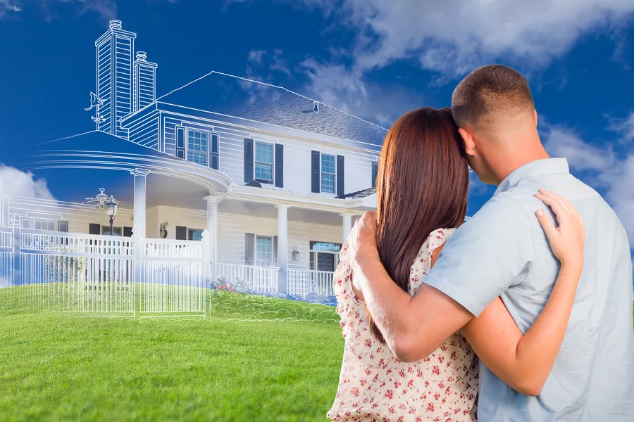 A couple looking at the plot on which they imagine their desired house